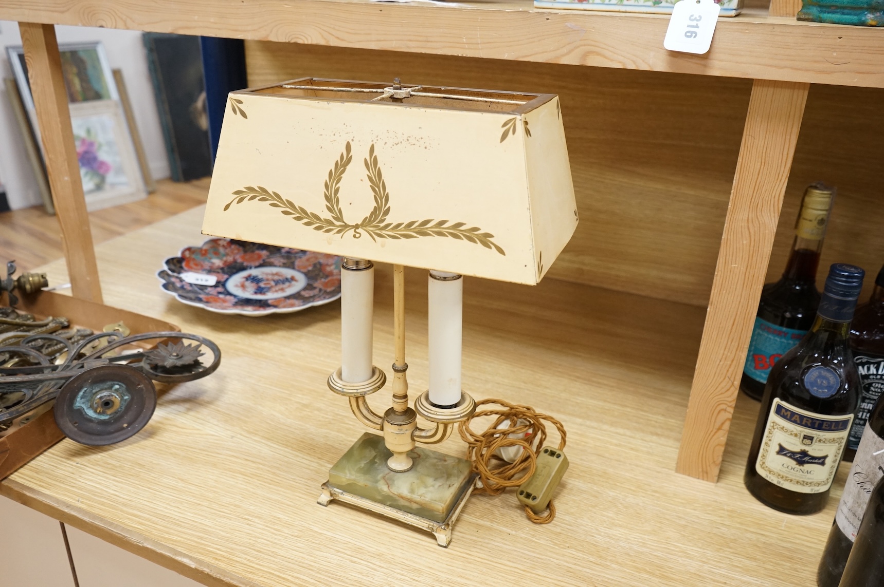 A cast brass wall sconce and a toleware two light lamp on onyx base, largest 46cm wide (2)
